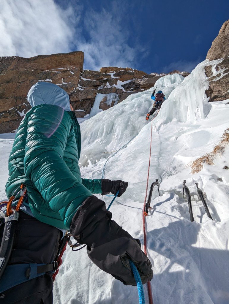 This February I joined two friends to ski up Glacier Gorge in Rocky Mountain National Park and sample some water ice at the head of the gorge. A sunny and fairly calm day with single digit temps, I was psyched to climb in an R1 fleece and windbreaker with just this featherweight down pullover to keep me warm during the belays. For each pitch I stuffed it in its pocket and clipped it to my harness.